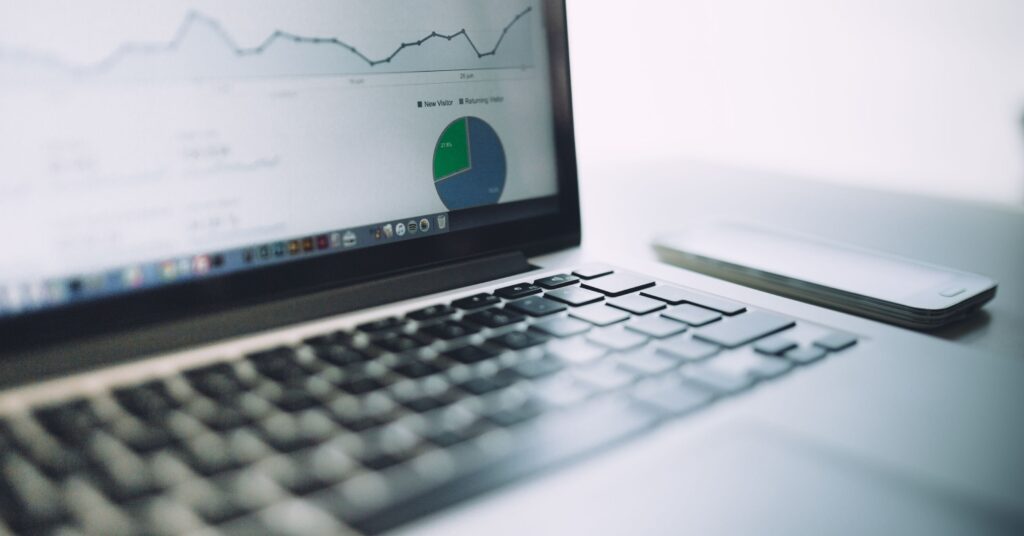 Laptop screen showing a sales funnel analytics dashboard with charts and conversion metrics